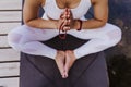 close up view of young beautiful asian woman doing yoga in a park. Sitting on the bridge with praying hands position and using Royalty Free Stock Photo