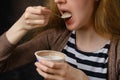 Close up view of unrecognizable young woman eating yogurt Royalty Free Stock Photo