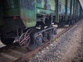 Close up view on used rusted railway freight car bogie with wheel sets with axleboxes, coil springs. Freight train on the railwayC