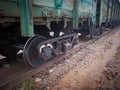 Close up view on used rusted railway freight car bogie with wheel sets with axleboxes, coil springs. Freight train on the railway Royalty Free Stock Photo