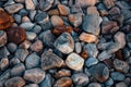 Close-up view of a variety of colored pebbles scattered across the surface, each of varying sizes Royalty Free Stock Photo