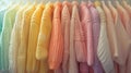 Close-up view of a variety of colorful youth cashmere sweaters and hoodies on a clothes rack, highlighting the detailed