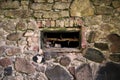 Close up view of a very old brick and stone wall with a window