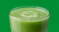 Vibrant Green Smoothie in Clear Glass Against Green Background