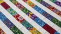 Vibrant Patchwork Quilt with White Quilted Stripes Royalty Free Stock Photo