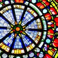 A close-up view of a vibrant stained glass window, casting a mesmerizing play of light and colors1, Generative AI