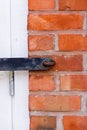 Close-up view of a vintage red brick wall with a closed window shutter Royalty Free Stock Photo