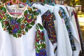 Close up view of vintage ukrainian clothes, vyshyvanka - traditional embroidered shirts on flea market or national
