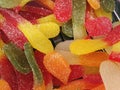 Close up view of vivid colorful sweet gummy fruit jelly in sugar, Candy background