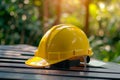 Close up view of a vivid yellow safety helmet placed on a table at a construction site Royalty Free Stock Photo