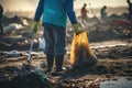 A close-up view of a volunteer diligently collecting garbage on a muddy beach