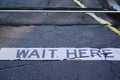 Wait Here Sign at Railway Crossing Royalty Free Stock Photo