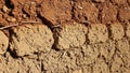Close-up of a wall constructed from rough, sun-baked adobe bricks with straw inclusions Royalty Free Stock Photo