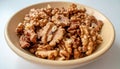 Walnut kernels in bowl, close-up food ingredient. Generated using AI. Royalty Free Stock Photo
