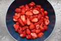 Close-up view of washed strawberries reflecting in a blue pot