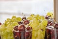 A close-up view of water drops falling on variety fresh red cherries and green grapes in a cups at local market for sale Royalty Free Stock Photo