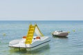 Close up view of water slide catamaran and rubber boat on sea coast on beautiful nature background. Royalty Free Stock Photo