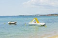 Close up view of water slide catamaran and rubber boat on sea coast on beautiful nature background.