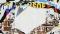 Abstract background of torn and peeling posters on a brick wall creating a textured and layered effect with space for text Royalty Free Stock Photo