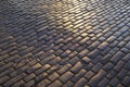 Close up view of wet, dark and sunlit cobble paved street, Edinburgh Royalty Free Stock Photo
