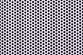 Close up view of white aluminum mesh. round holes in the iron grid. Perforated steel mesh texture with small holes