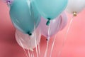 Close up view of white, blue and purple balloons on pink background. Royalty Free Stock Photo