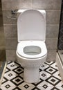 Close up view of white ceramic toilet in modern bathroom. Open toilet bowl. White hanging toilet seat on white toilet in the home Royalty Free Stock Photo
