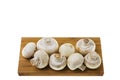Close up view of white champignon mushrooms on wooden cutting board Royalty Free Stock Photo