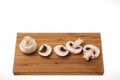 Close up view of white champignon mushrooms on wooden cutting board Royalty Free Stock Photo