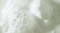 Close-up view of white foam bubbles on a smooth surface, creating a soft and creamy texture, ideal for backgrounds or product Royalty Free Stock Photo