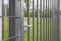 A close-up view of the white handle on the steel fence gate.