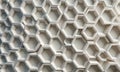 close-up view white, honeycomb-like pattern on surface, with repeating hexagonal shape and varying shades