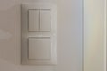 Close up view of white light switch pair on wall . Building construction elements concept. Royalty Free Stock Photo