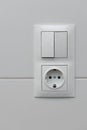 Close up view of white light swithch and socket pair on white tile. Building construction elements concept. Interior. Design Royalty Free Stock Photo