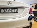 Close-up view of a white Mercedes Benz in the process of being electrically charged