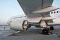 Close-up view of a white passenger jet plane from under the wing