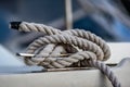 Close up view of white rope tied around ship bollard