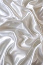 Close-up view of white satin fabric with intricate texture, interplay of, shadow. Fabric folded in half to smooth surface. Dark Royalty Free Stock Photo