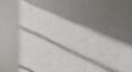 Textured White Wall with Diagonal Shadow Lines Casting a Subtle Geometric Pattern Across the Surface Royalty Free Stock Photo