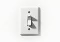 Close up view of a white toggle light switch in the middle of a white wall Royalty Free Stock Photo