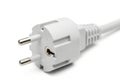 A close-up view of a white two-prong electrical power adapter with a coiled cord Royalty Free Stock Photo