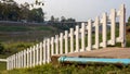 A close-up view of a white wooden fence stretched across the lawn near a concrete platform Royalty Free Stock Photo