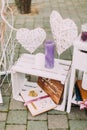 Close-up view of the white wooden vintage crate with colourful candles, albums and handmade hearts.
