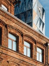 Close up view on windows in brick wall of the building with a abstract office fasade on the background