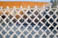 Close-up view of a wire fence with frost with ice crystals under a blue sky with a blurred background Royalty Free Stock Photo