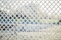 Close-up view of a wire fence with frost with ice crystals under a blue sky with a blurred background Royalty Free Stock Photo