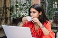 Close-up view of woman drinking coffee while working