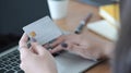 Woman hand holding plastic credit card and using laptop. Online shopping, internet banking concept. Royalty Free Stock Photo