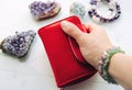 Close up view of woman hand holding red money wallet. Royalty Free Stock Photo