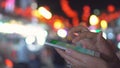 Close up view of woman hand that writing message on her smartphone against evening light background